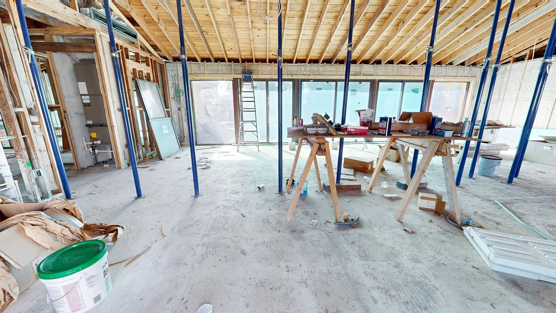 Timber roof framing and temporary supports inside a building under construction